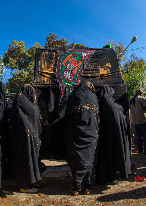 Iranian Shiite Muslim Women Covered In Mud Crying In Front Of A Coffin During Ashura, The Day Of The Death Of Imam Hussein, Kurdistan Province, Bijar, Iran