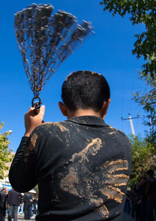 Iranian Shiite Boy Covered In Mud Is Beating Himself With Iron Chains To Commemorate Ashura, The Day Of The Death Of Imam Hussein, Kurdistan Province, Bijar, Iran