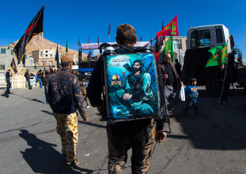 Iranian Shiite Muslim Man Carrying A Tank Of Rose Water With Iman Hussein Representation On It During Ashura, Kurdistan Province, Bijar, Iran