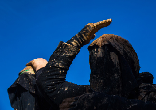 Iranian Shiite Muslim Woman Covered In Mud, Chanting And Self-flagellating During Ashura, The Day Of The Death Of Imam Hussein, Kurdistan Province, Bijar, Iran