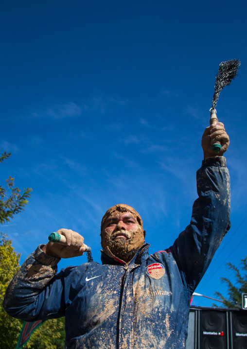 Iranian Shiite Man Covered In Mud Is Beating Himself With Iron Chains To Commemorate Ashura, The Day Of The Death Of Imam Hussein, Kurdistan Province, Bijar, Iran