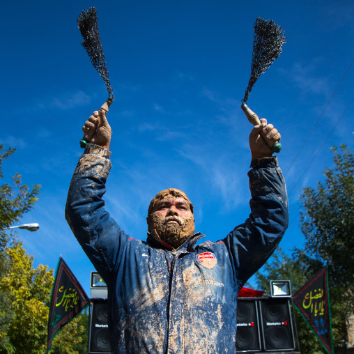 Iranian Shiite Man Covered In Mud Is Beating Himself With Iron Chains To Commemorate Ashura, The Day Of The Death Of Imam Hussein, Kurdistan Province, Bijar, Iran