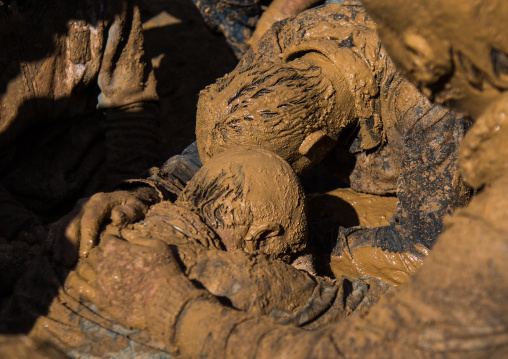 Iranian Shiite Muslim Men Covered In Mud Crying Together During Ashura, The Day Of The Death Of Imam Hussein, Kurdistan Province, Bijar, Iran
