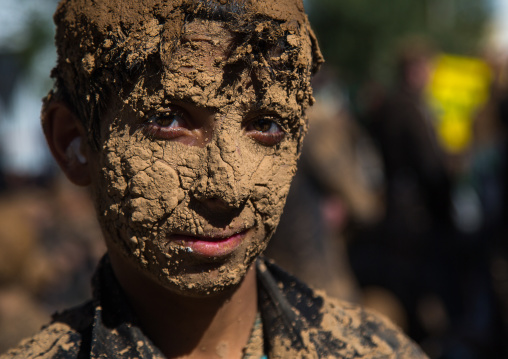 Iranian Shiite Muslim Boy Covered In Mud During Ashura, The Day Of The Death Of Imam Hussein, Kurdistan Province, Bijar, Iran