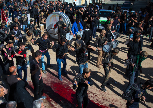 Iranian Shiite Men Covered In Mud Are Beating Themselves With Iron Chains During Ashura, The Day Of The Death Of Imam Hussein, Kurdistan Province, Bijar, Iran