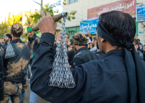 Iranian Shiite Men Covered In Mud Are Beating Themselves With Iron Chains During Ashura, The Day Of The Death Of Imam Hussein, Kurdistan Province, Bijar, Iran