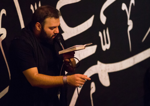 Iranian Shiite Muslim Man Leading Recitations And Songs With The Mad Of Hussein Mourners During Muharram, Isfahan Province, Kashan, Iran