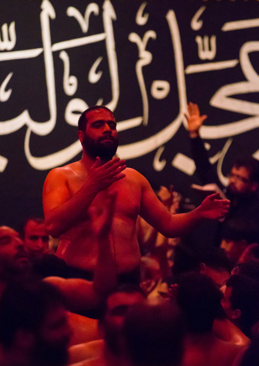 Iranian Shiite Muslim Man Leading Recitations And Songs With The Mad Of Hussein Mourners During Muharram, Isfahan Province, Kashan, Iran
