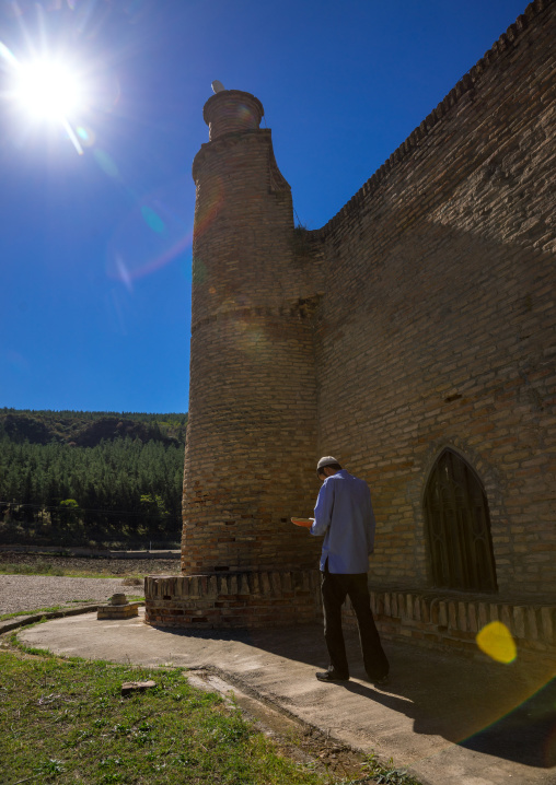 Iranian Shiite Student Reading Koran In Front Of A Caravanserai Turned Into Madrassah, Golestan Province, Karim Ishan, Iran