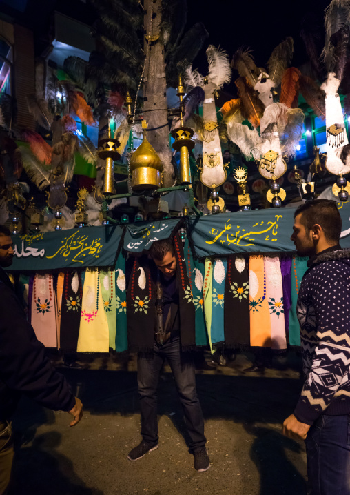 An Iranian Man Carries An Alam Is Helped By Shiite Muslim Mourners To Keep His Balance On Ashura, The Day Of The Death Of Hussein, Golestan Province, Gorgan, Iran