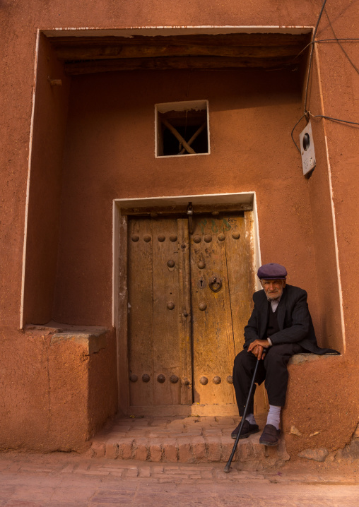 Old Man Sitting In Front Of An Ancient Building In Zoroastrian Village, Isfahan Province, Abyaneh, Iran