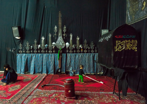 Little Boy Playing With An Aspirator In Front Of An Alam On Ashura, The Day Of The Death Of Imam Hussein, Isfahan Province, Kashan, Iran
