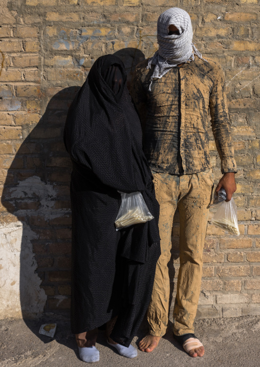 Iranian Shiite Muslim Couple Mourning Imam Hussein On The Day Of Tasua With Their Faces Covered By A Veil, Lorestan Province, Khorramabad, Iran