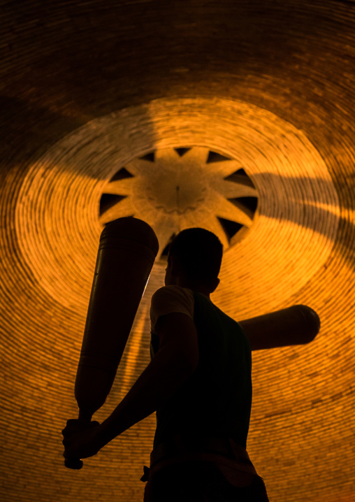 Iranian Man Wielding Wooden Clubs During The Traditional Sport Of Zurkhaneh, Yazd Province, Yazd, Iran