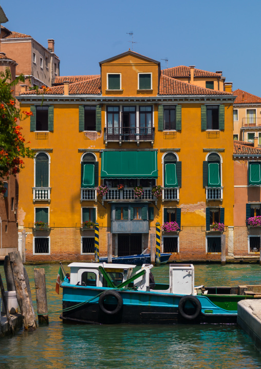 Venetian decayed facades and reflections on a canal, Veneto Region, Venice, Italy