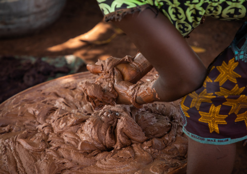 Senufo woman prepairing shea butter in a traditional karité factory, Savanes district, Tcheregnimin, Ivory Coast
