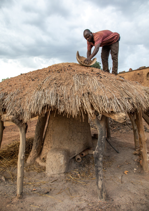 Senufo blacksmith putting charcoal from the top of the house, Poro region, Koni, Ivory Coast