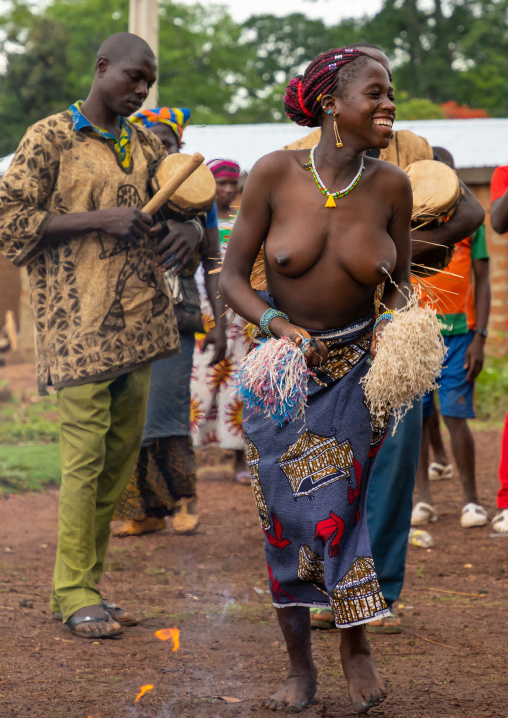 Young Senufo shirtless woman dancing the Ngoro during a ceremony, Savanes district, Ndara, Ivory Coast