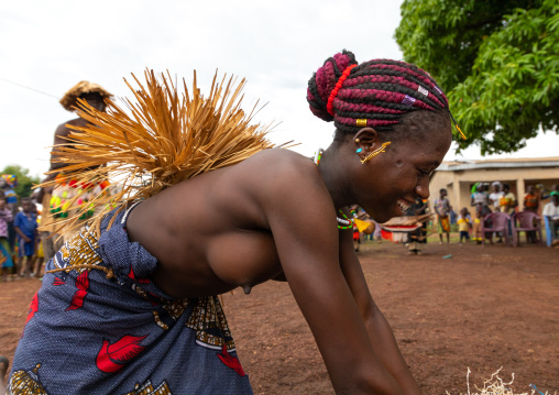 Young Senufo shirtless woman dancing the Ngoro during a ceremony, Savanes district, Ndara, Ivory Coast