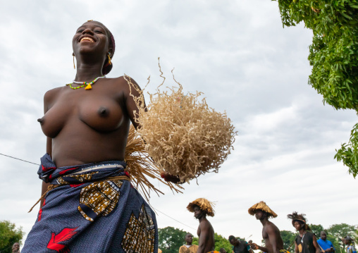 Young Senufo shirtless woman dancing the Ngoro during a ceremony, Savanes district, Ndara, Ivory Coast