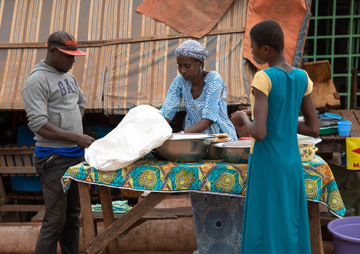 African woman sellling food in the sreet, Savanes district, Boundiali, Ivory Coast