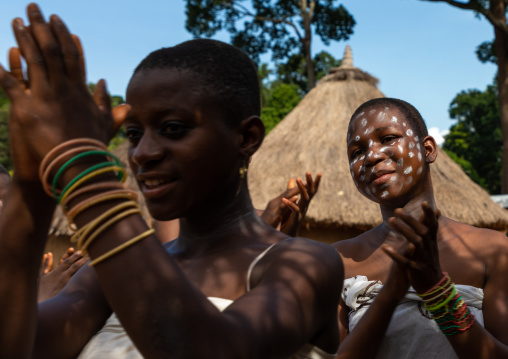 Dan tribe young women clapping hands and dancing during a ceremony, Bafing, Gboni, Ivory Coast