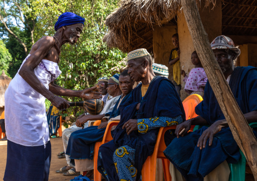 Senior Dan tribe woman begging for money to the chiefs during a ceremony, Bafing, Gboni, Ivory Coast