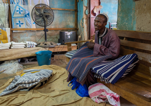 Man buying african fabrics in a shop, Tonkpi Region, Man, Ivory Coast