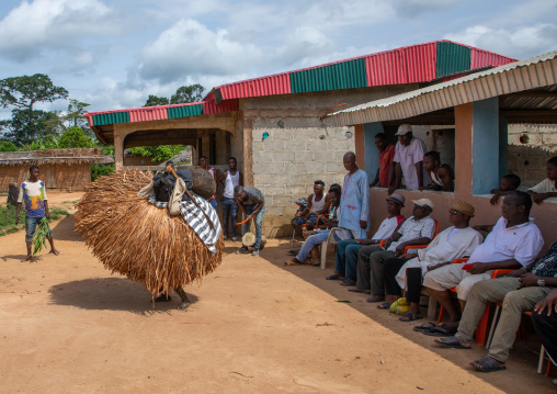 We Guere sacred mask dance in front of the village leaders during a ceremony, Guémon, Bangolo, Ivory Coast