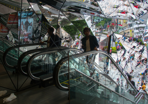 Walking people reflected on glass in tokyu plaza i, Kanto region, Tokyo, Japan