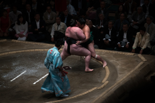 Two sumo wrestlers fighting at the ryogoku kokugikan arena, Kanto region, Tokyo, Japan