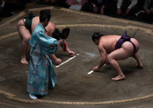 Two sumo wrestlers fighting at the ryogoku kokugikan arena, Kanto region, Tokyo, Japan