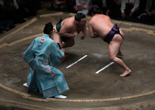 Two sumo wrestlers fighting at the ryogoku kokugikan arena, Kanto region, Tokyo, Japan
