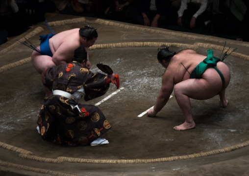 Two sumo wrestlers fighting at the ryogoku kokugikan arena, Kanto region, Tokyo, Japan