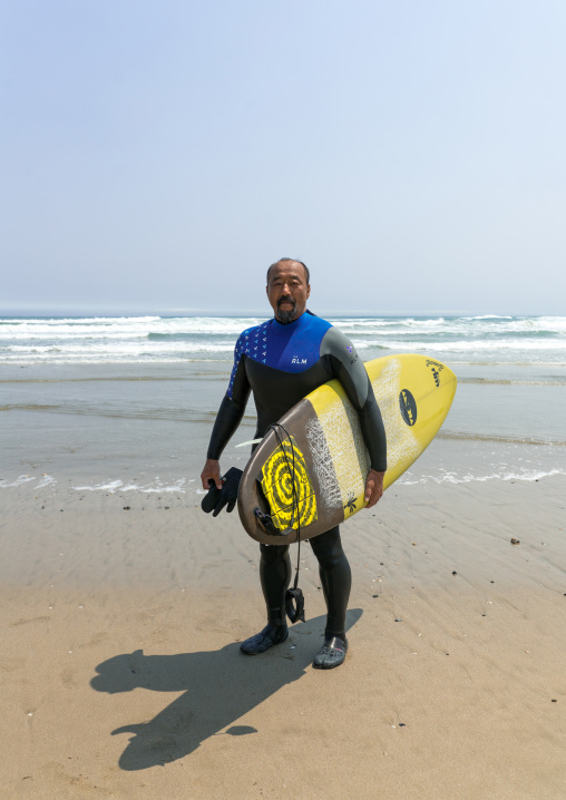 Japanese surfer in the contaminated area after the daiichi nuclear power plant irradiation, Fukushima prefecture, Tairatoyoma beach, Japan