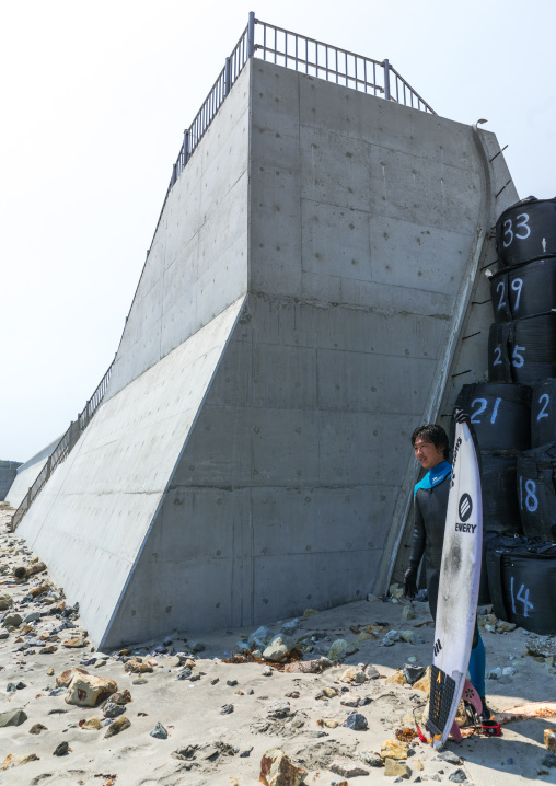 Japanese surfer in the contaminated area after the daiichi nuclear power plant irradiation, Fukushima prefecture, Tairatoyoma beach, Japan