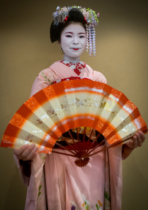 16 Years old maiko called chikasaya dancing with a fan, Kansai region, Kyoto, Japan