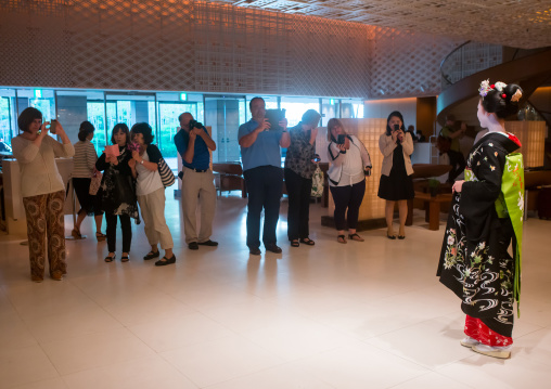 Maiko in hayatt hotel hall posing for tourists, Kansai region, Kyoto, Japan