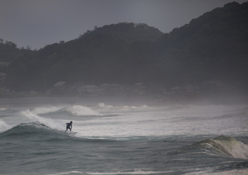 Japanese surfer in the contaminated area after the daiichi nuclear power plant irradiation, Fukushima prefecture, Tairatoyoma beach, Japan