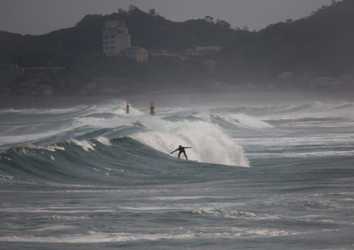 Japanese surfer in the contaminated area after the daiichi nuclear power plant irradiation, Fukushima prefecture, Tairatoyoma beach, Japan