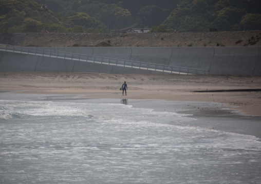 Japanese surfer in the contaminated area after the daiichi nuclear power plant irradiation, Fukushima prefecture, Tairatoyoma beach, Japan