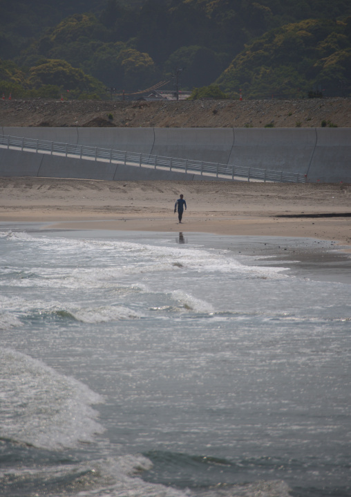 Japanese surfer in the contaminated area after the daiichi nuclear power plant irradiation, Fukushima prefecture, Tairatoyoma beach, Japan