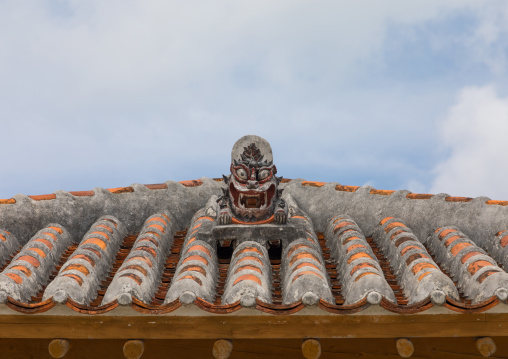 Shisa lion atop traditional tile roof to protect the house from the bad spirits, Yaeyama Islands, Taketomi island, Japan
