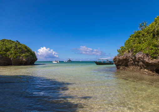 Tropical lagoon with clear blue water surrounded by lush greenery in Kabira bay, Yaeyama Islands, Ishigaki, Japan