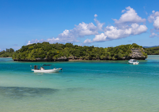 Glass bottom boats in the tropical lagoon beach with clear blue water in Kabira bay, Yaeyama Islands, Ishigaki, Japan