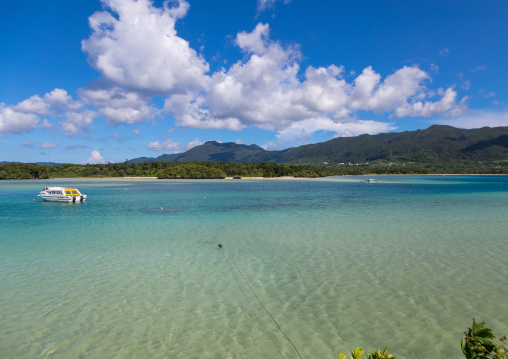 Glass bottom boats in the tropical lagoon beach with clear blue water in Kabira bay, Yaeyama Islands, Ishigaki, Japan