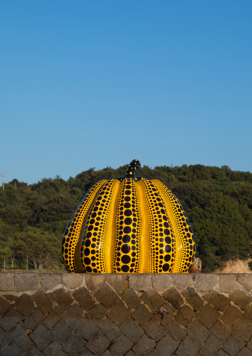 Yellow pumpkin by Yayoi Kusama on pier at sea, Seto Inland Sea, Naoshima, Japan