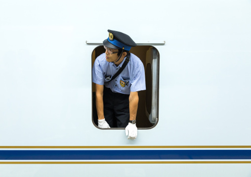Shinkansen train controller looking thru a window, Hypgo Prefecture, Himeji, Japan