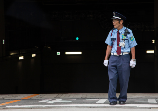 Senior japanese security guard in the street, Kansai region, Osaka, Japan