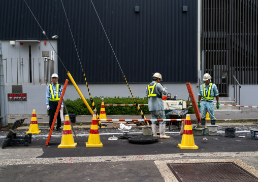 Japanese workers repairing the road, Ishikawa Prefecture, Kanazawa, Japan